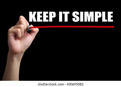 Hand is drawing a red line under the text Keep It Simple with black background.