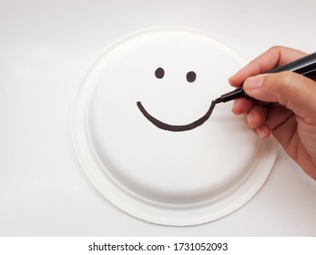 Hand drawing symbol happy smile face on back paper plate. Happy Concept.