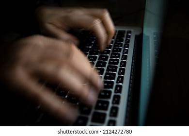 hand drawn on a computer keyboard. The human hand is drawn in blur to create the perception of motion. human hand typing on keyboard.