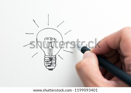 Hand drawn shining light bulb isolated on white background