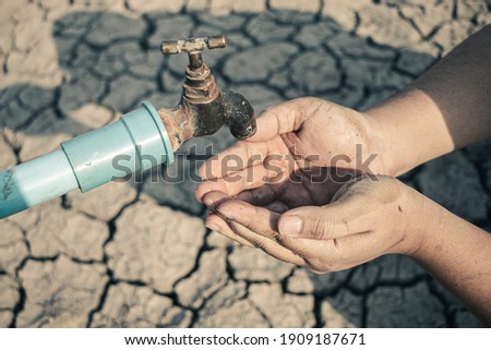 Hand for drinking water to live through drought, Concept drought and crisis environment.
