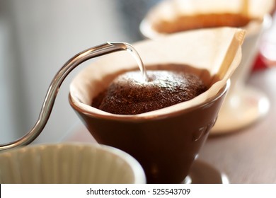Hand drip coffee , Barista pouring water on coffee ground with filter