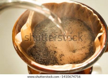 Hand drip coffee , Barista pouring water on coffee ground with filte