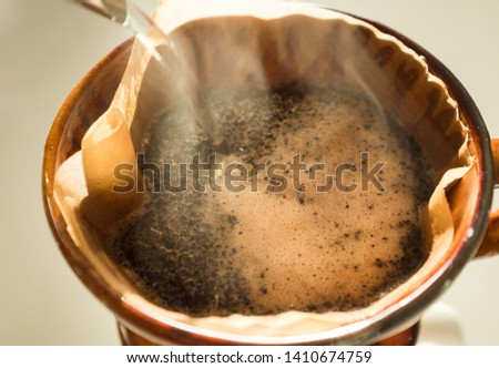 Hand drip coffee , Barista pouring water on coffee ground with filte