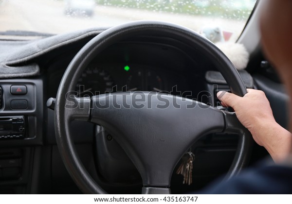hand drive car in rainy ,transport, business trip,\
speed, destination and people concept - close up of young man\
driving car.
