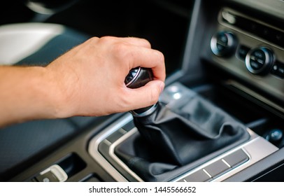 Hand of the driver on the gear knob in the car. Transport concept and manual transmission. Driving, transmission failure.