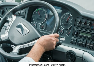 Hand Of A Driver On Steering Wheel At Intercity Coach Bus. Focus On Steering Wheel. Blurry Control Panel Buttons And Dials On The Background. Man Driving Bus On The Highway.