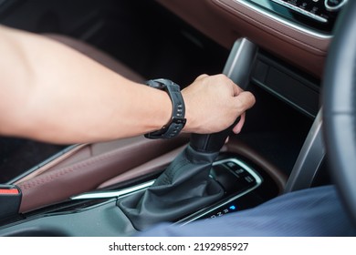 hand driver stick shift transmission a car gear, hand controlling steering wheel during vehicle moving. Journey, trip and safety Transportation concepts