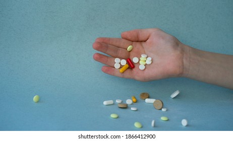 Hand Dropping Pills On The Table. Image With Selective Focus