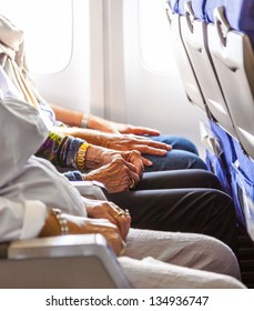 hand of an elderly lady sitting in the aircraft
