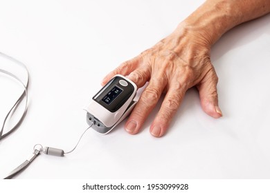 Hand of the elderly used a Pulse oximeter and oxygen levels on white  - Powered by Shutterstock