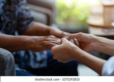 Hand of elderly woman holding hand younger woman, Helping hands, take care for the elderly concept.