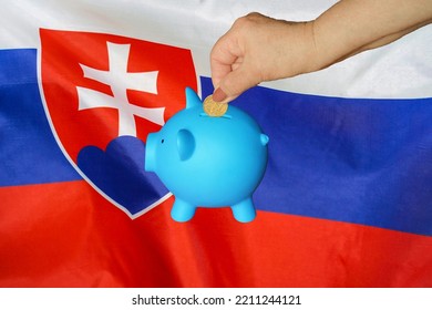 Hand of elderly woman putting coin into piggy bank on Slovakia flag background. Hand putting coin to piggy bank. Retirement savings, piggy bank. Concept saving money and retirement fund in Slovakia - Shutterstock ID 2211244121