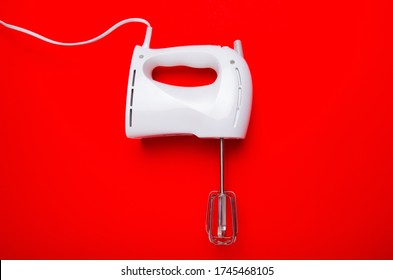 Hand Electric Blender Mixer On Red Background. Flat Lay, Top View, Copy Space.