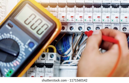 Hand Of An Electrician With Multimeter Probe At An Electrical