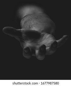 
A hand emerging from darkness