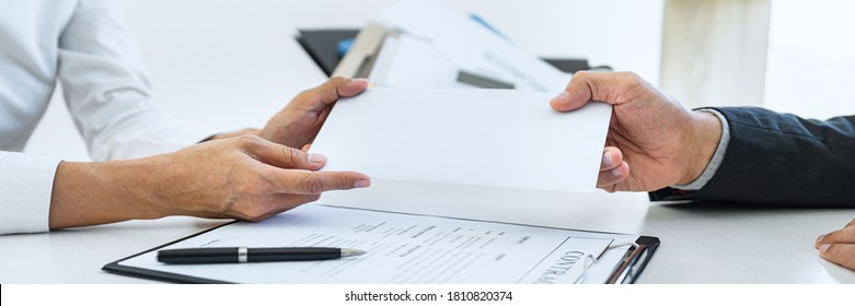 Hand of employer filing final remuneration after employee to write a document letter of resignation, resign concept. - Shutterstock ID 1810820374