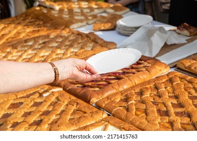 Hand With Empty Paper Plate Waits For Portion Of Open Sweet Pie