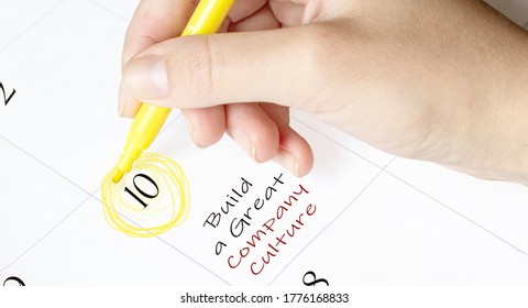 Hand Encircles A Date On A Calendar With Text Build A Great Company Culture Yellow Felt-tip Pen