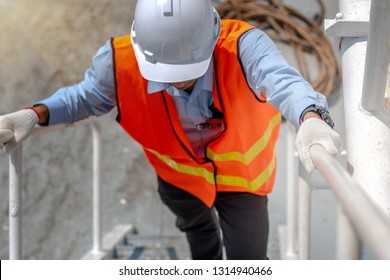 hand of engineering, technician, motorman, or machanic holding handrail in hurry upstiar running,  to reach destination in time, working at risk in high level of insurance   - Powered by Shutterstock