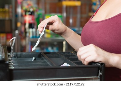 Hand Of Enterprising Latina Woman In Her Grocery Store, Opening The Cash Register To Take Out A Two Thousand Colombian Pesos Bill. Girl Making A Sale. Concept Of Economy