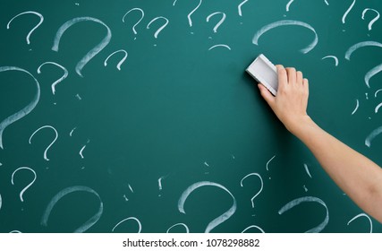 Hand Erasing Question Mark On Chalkboard