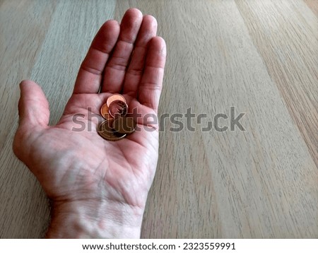 hand of european man showing a few euros in the palm of the hand (concept economic poverty)
