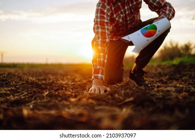 Hand of expert farmer collect soil and checking soil health before growth a seed of vegetable or plant seedling. Agriculture, gardening or ecology concept.