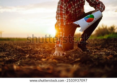 Hand of expert farmer collect soil and checking soil health before growth a seed of vegetable or plant seedling. Agriculture, gardening or ecology concept.