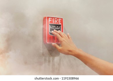 The Hand Extended To The Fire Alarm Warning Device.