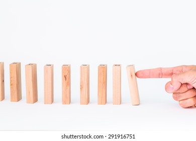 Hand And Falling Wood Pieces Dominoes On White Background