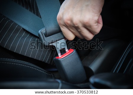 Hand fastening seat belt in the car