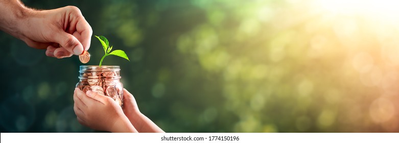  Hand Of Father Adding Penny To Child's Coin Jar With Plant Growing Out Of It - College Fund / Investing In Our Children's Future Concept - Shutterstock ID 1774150196