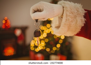 Hand Of Father Christmas Holding Car Key At Home In The Living Room