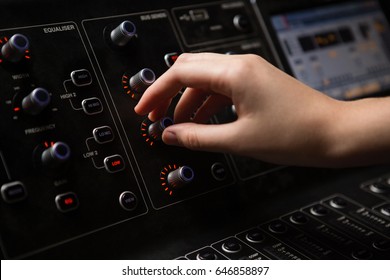 Hand Of Female Audio Engineer Using Sound Mixer In Recording Studio