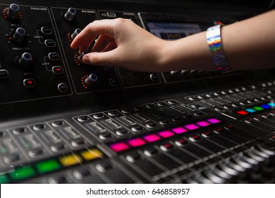 Hand Of Female Audio Engineer Using Sound Mixer In Recording Studio