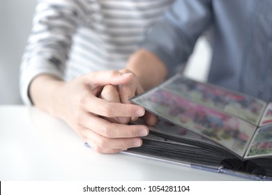 Hand In Hand, Female And Old Female See A Photo Book, Female Holding Hand Of Her Mother, Family Time