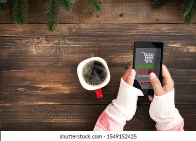 Hand Of Female Using Mobile Phone To Online Shopping. Christmas And New Year Holiday Online Shopping Concept. Big Sale In Winter Holiday.