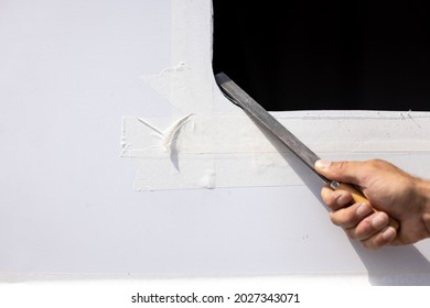 Hand with a file deburring a metal sheet - Shutterstock ID 2027343071