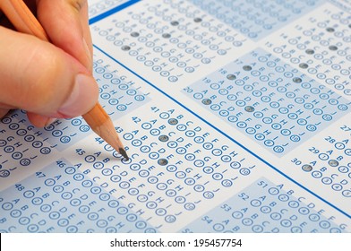 hand filling out answers to standard answer sheet