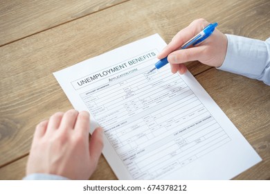 Hand Filling The Unemployment Benefit Application