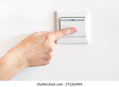 Hand With Finger On Light Switch