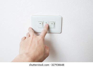 Hand With Finger On Light Switch