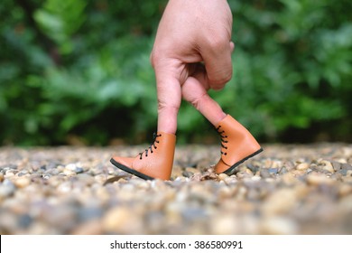 Hand Finger Walking in Garden With Shoe Concept, Traveler adventure outdoor summer vacations concept, 
Healthy lifestyle concept. Stay at home quarantine for coronavirus.