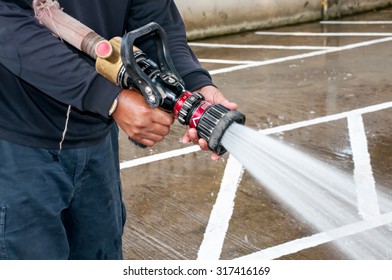 Hand Of Firefighter At Works With Water Cannon