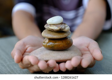 Hand and five stone