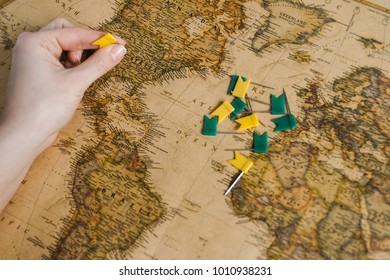 Hand with flags above the map