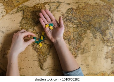 Hand with flags above the map