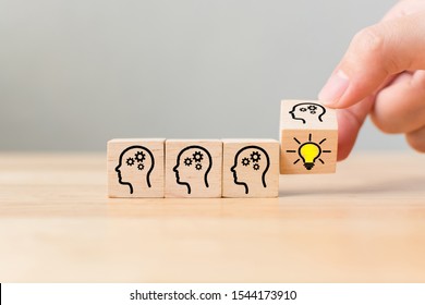 Hand flip over wooden cube block with head human symbol and light bulb icon. Concept creative idea and innovation - Shutterstock ID 1544173910