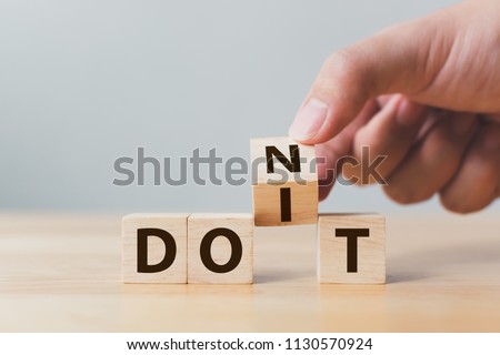 Hand flip wooden cube block with word don’t change to do it. Personal development and career growth or change yourself concept Stockfoto © 